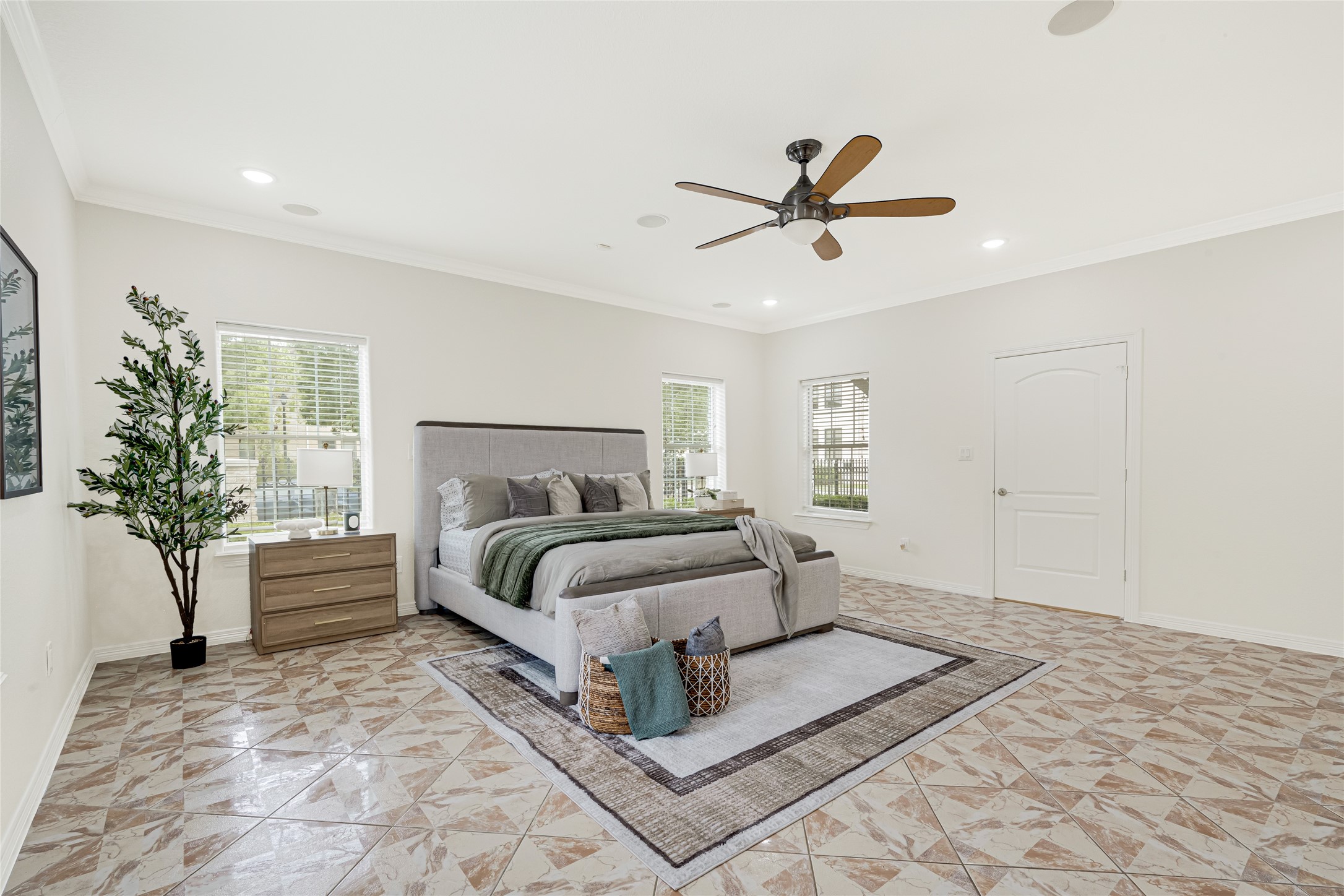 404 Moss Street Houston, TX 77009 - Photo 16 of 39 a spacious bedroom with a bed and a chandelier