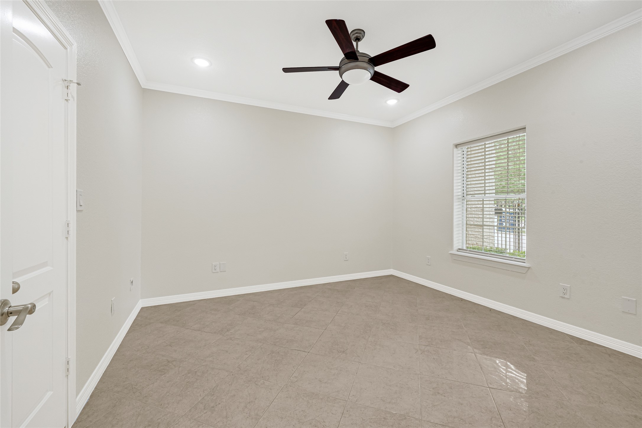 404 Moss Street Houston, TX 77009 - Photo 22 of 39 an empty room with a ceiling fan and windows