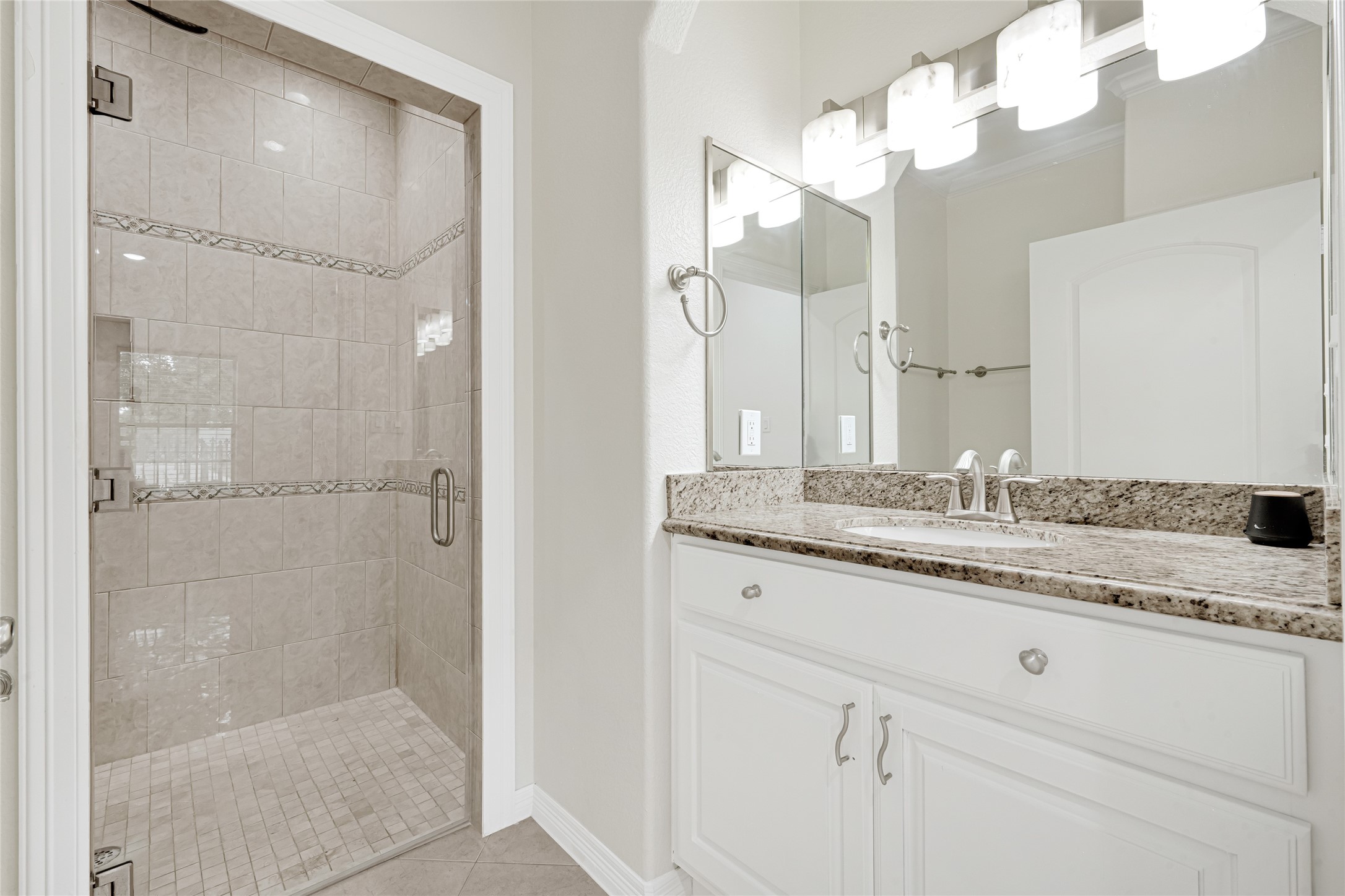 404 Moss Street Houston, TX 77009 - Photo 25 of 39 a bathroom with a granite countertop sink mirror and shower