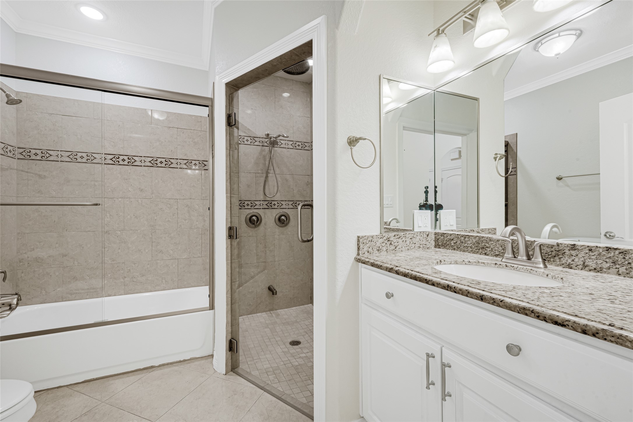 404 Moss Street Houston, TX 77009 - Photo 27 of 39 a bathroom with a granite countertop sink mirror and shower