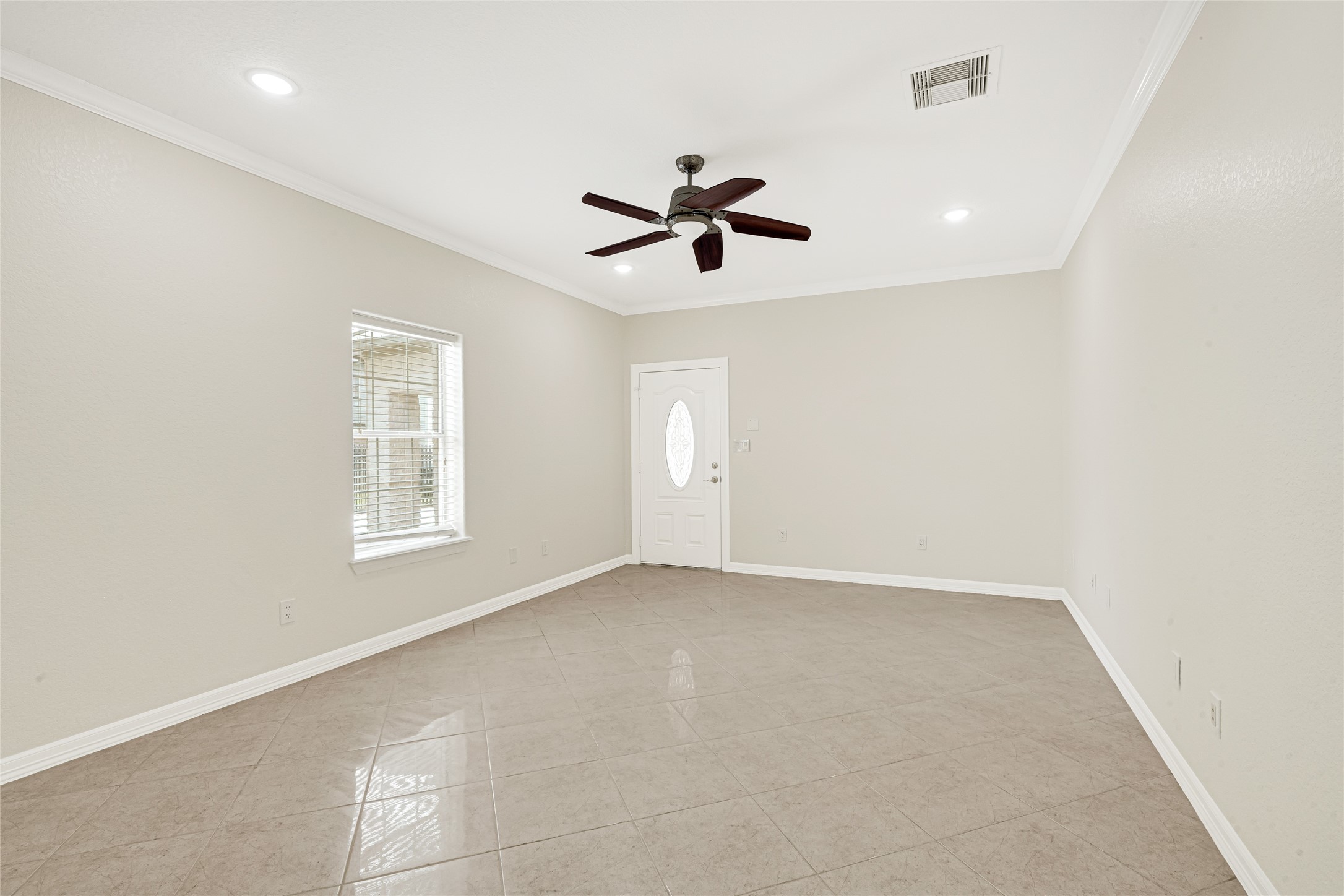 404 Moss Street Houston, TX 77009 - Photo 30 of 39 an empty room with windows and fan