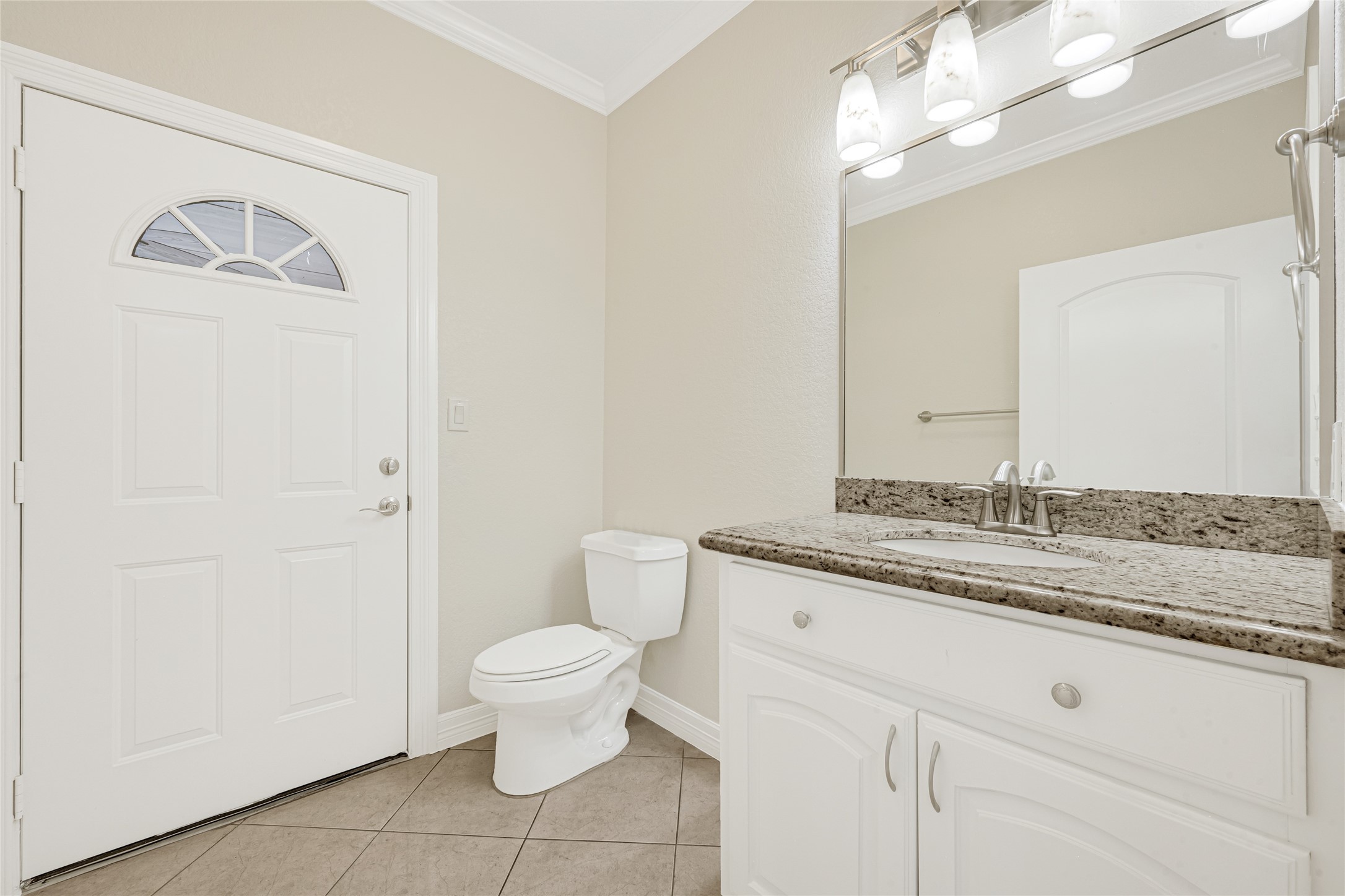 404 Moss Street Houston, TX 77009 - Photo 31 of 39 a bathroom with a granite countertop sink a toilet and a mirror
