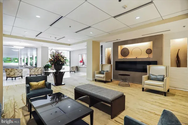 a living room with fireplace furniture and a large window