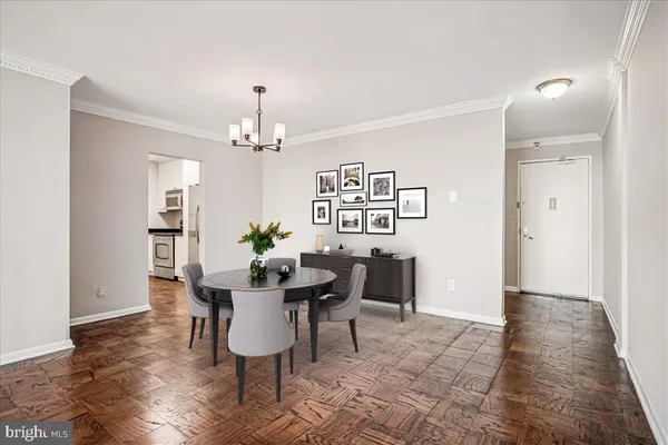 a dining room with furniture potted plants and wooden floor