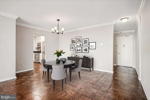 a dining room with furniture potted plants and wooden floor