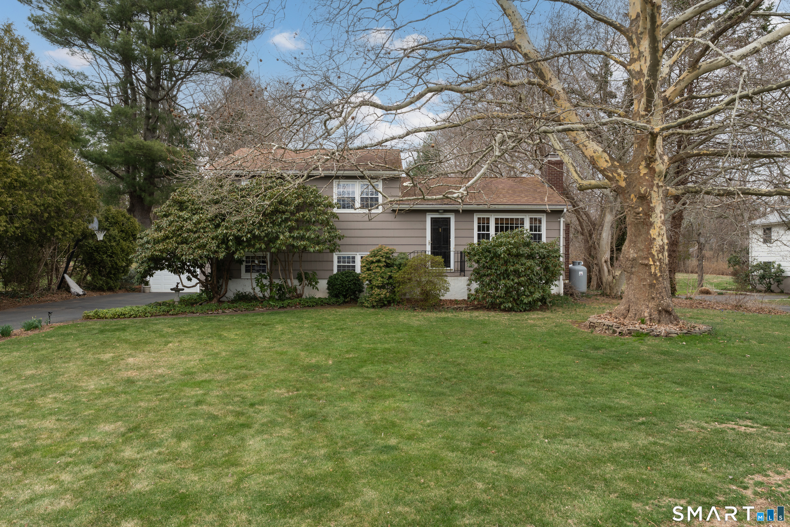 82 Raymond Road Guilford, CT 06437 - Photo 1 of 33 a front view of house with yard and trees in the background