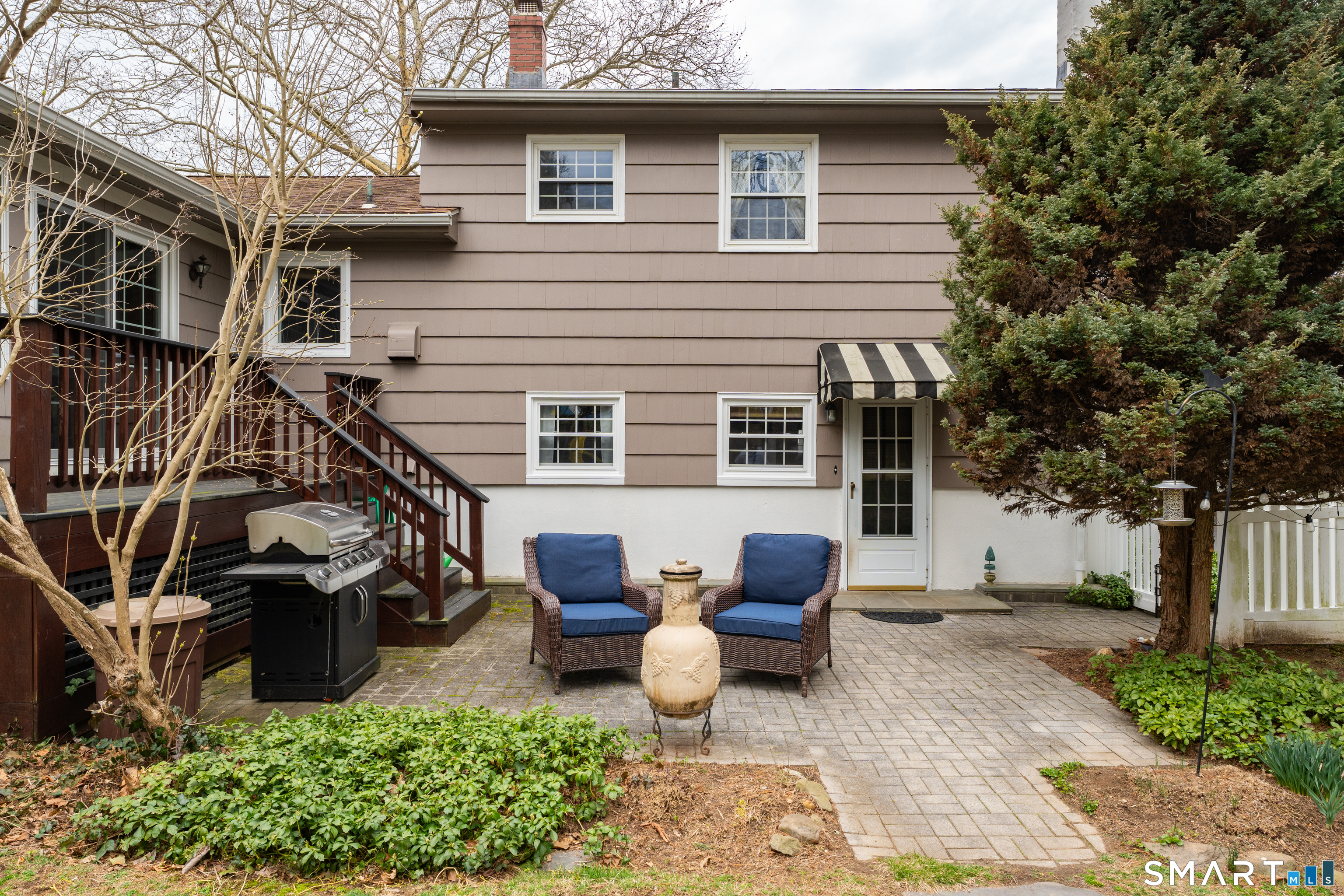 82 Raymond Road Guilford, CT 06437 - Photo 23 of 33 a view of a patio with table and chairs with wooden fence and plants