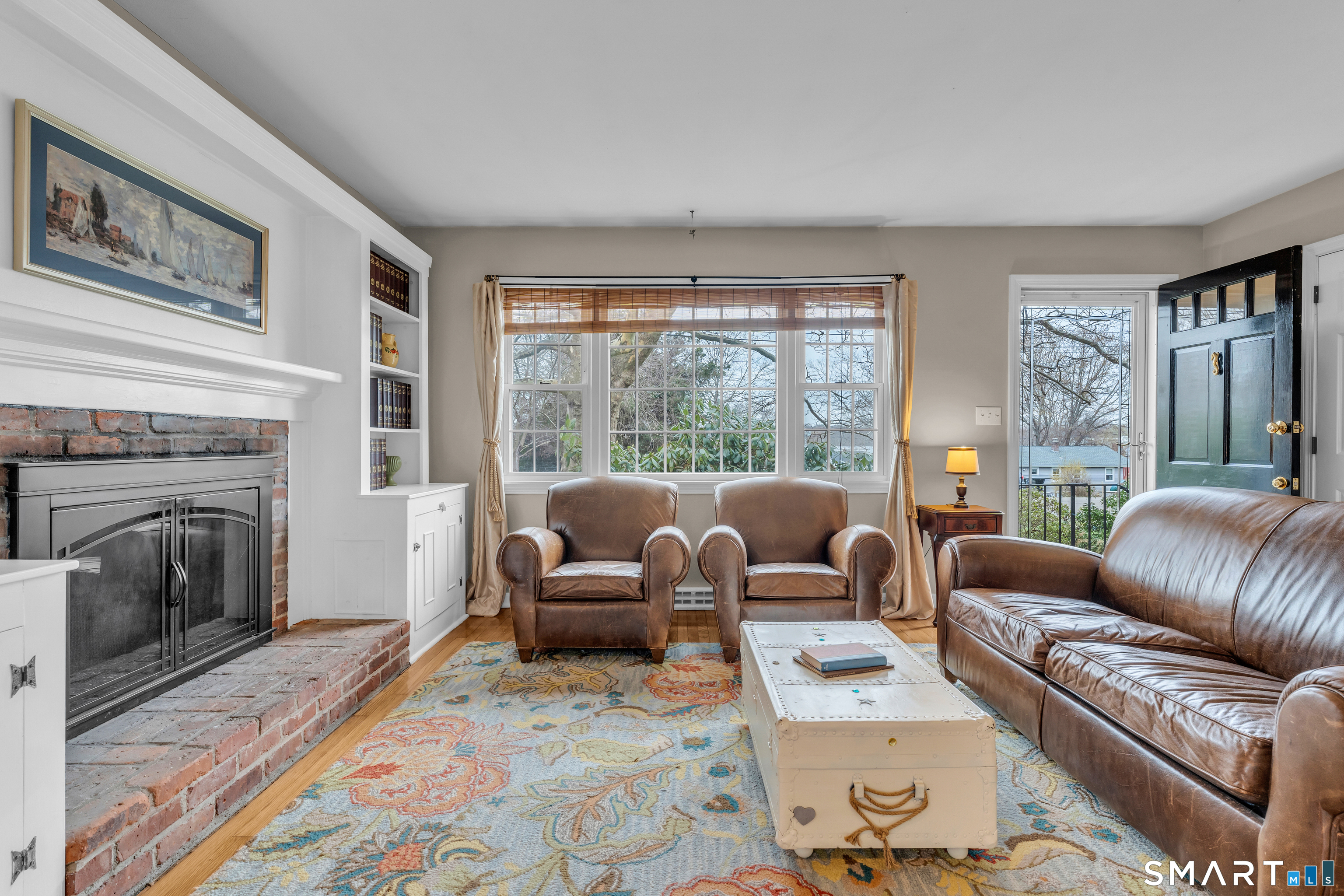 82 Raymond Road Guilford, CT 06437 - Photo 4 of 33 a living room with furniture large window and a fireplace