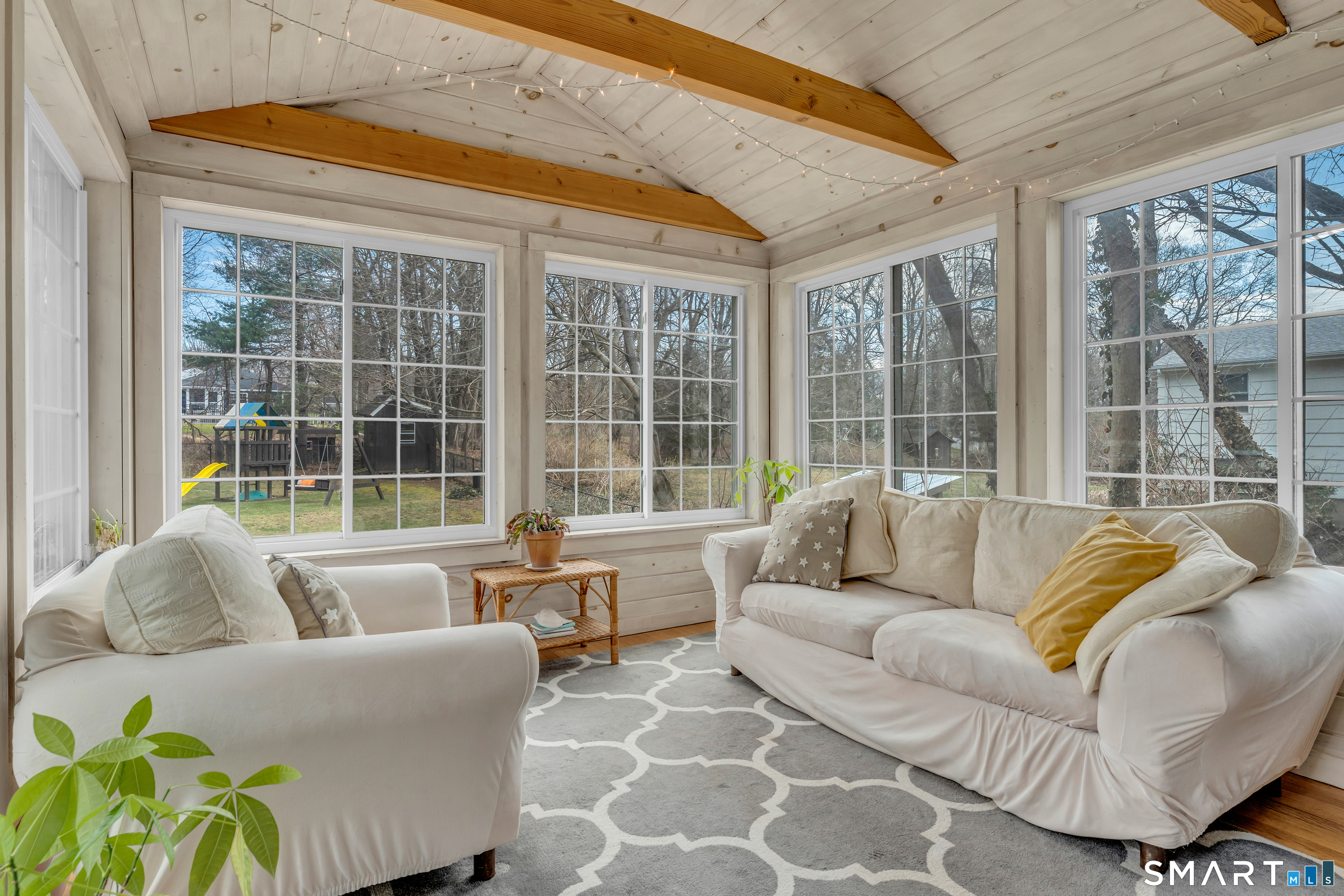 82 Raymond Road Guilford, CT 06437 - Photo 10 of 33 a living room with furniture and a large window