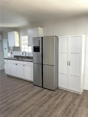 a kitchen with stainless steel appliances a refrigerator sink and cabinets