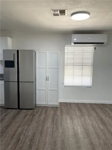 a view of an empty room with a kitchen