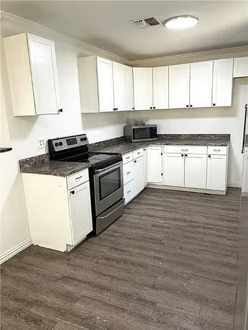 a white kitchen with granite countertop stainless steel appliances