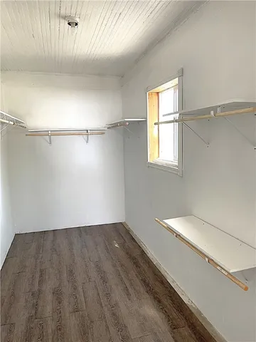 a view of a room with wooden floor and white walls