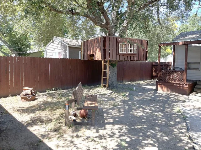 a view of a patio with table and chairs