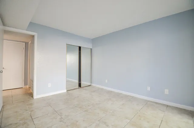 a view of an empty room and closet area