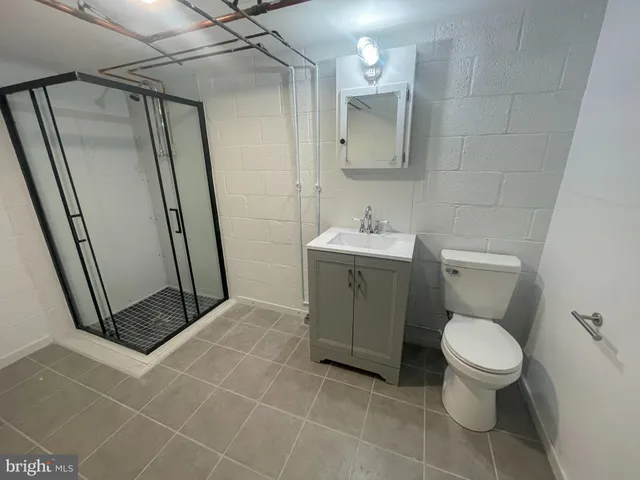 a bathroom with a toilet a sink and a mirror