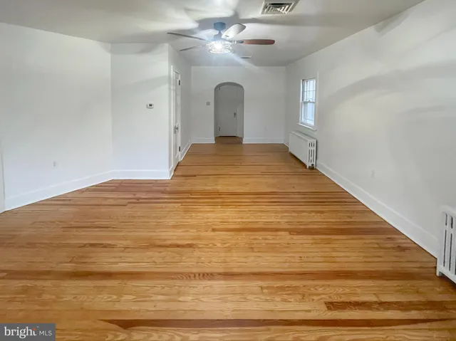 a view of a big room with wooden floor and chandelier
