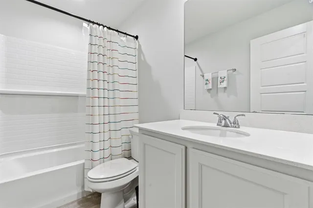a living room with furniture and a ceiling fan