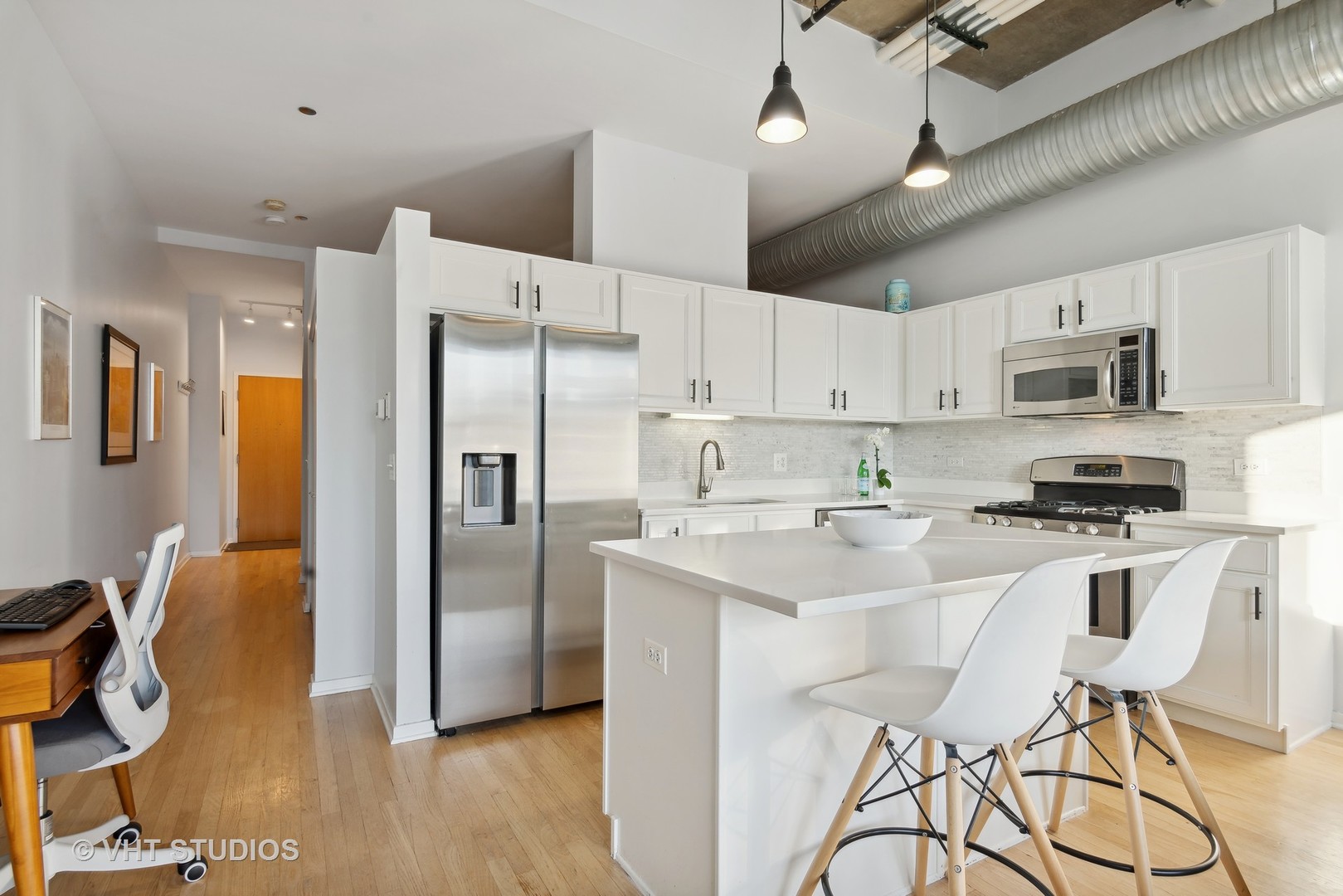 849 North Franklin Street, Unit 1419 Chicago, IL 60610 - Photo 3 of 10 a kitchen with stainless steel appliances a refrigerator stove microwave and cabinets