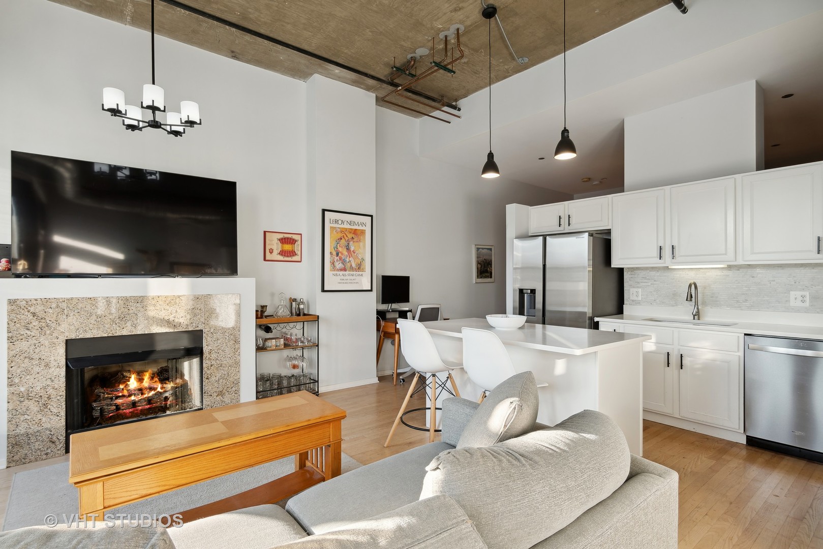 849 North Franklin Street, Unit 1419 Chicago, IL 60610 - Photo 6 of 10 a living room with stainless steel appliances furniture a fireplace and a flat screen tv