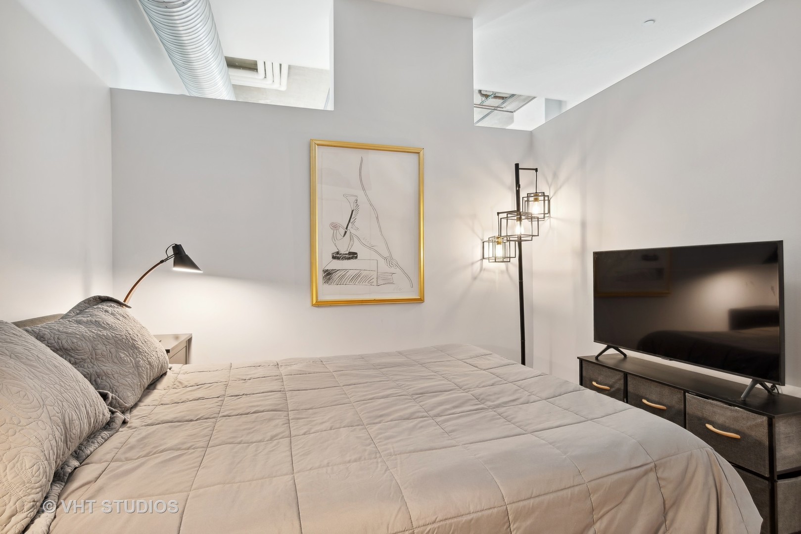 849 North Franklin Street, Unit 1419 Chicago, IL 60610 - Photo 7 of 10 a bedroom with a bed and a flat screen tv