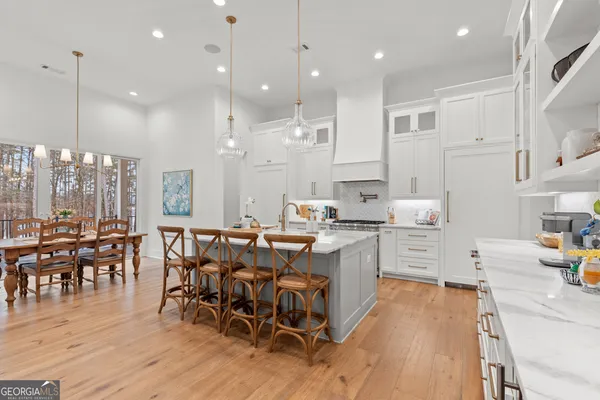a bedroom with a bed a table and wooden floor