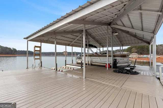 a dining hall with stainless steel appliances kitchen island granite countertop a dining table chairs and view living room