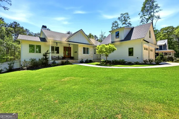 a front view of a house with a garden
