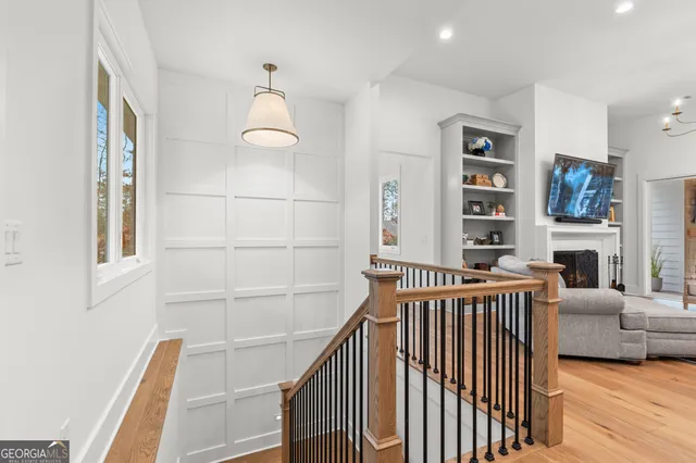 a living room with furniture floor to ceiling window and a flat screen tv