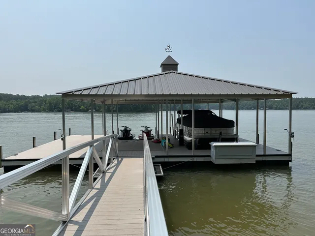 a view of a patio with a table and chairs under an umbrella