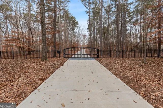 a view of a patio with a table and chairs under an umbrella