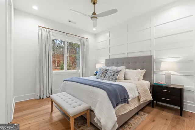 a bedroom with 2 bed and a window