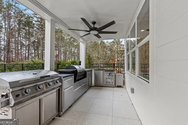 a dining hall with stainless steel appliances kitchen island granite countertop a dining table chairs and view living room