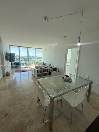 a view of a dining room with furniture and a window