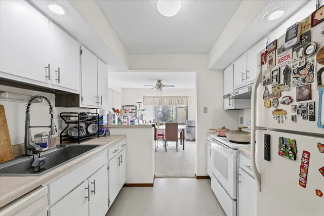 a kitchen with stainless steel appliances a sink a stove top oven a counter space and cabinets