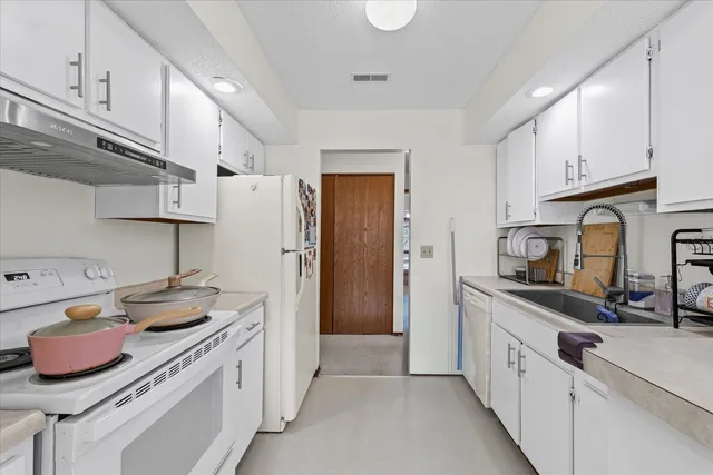 a kitchen with stainless steel appliances granite countertop a sink and cabinets
