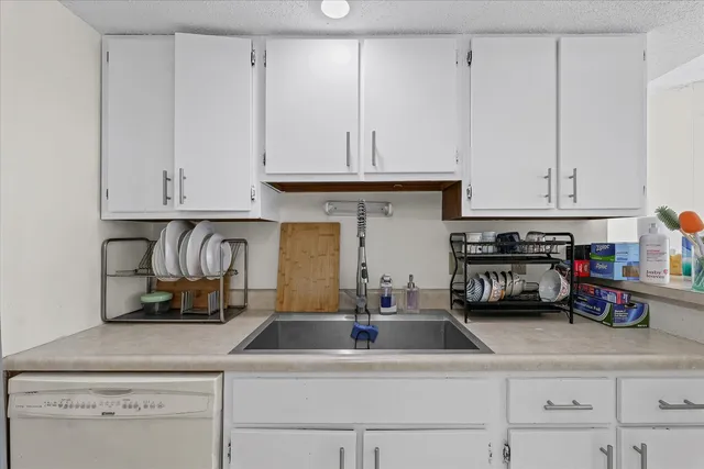 a kitchen with white cabinets and a sink