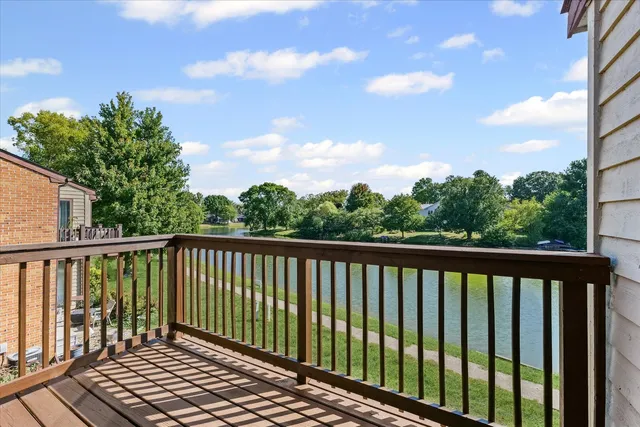 a balcony with wooden floor and fence