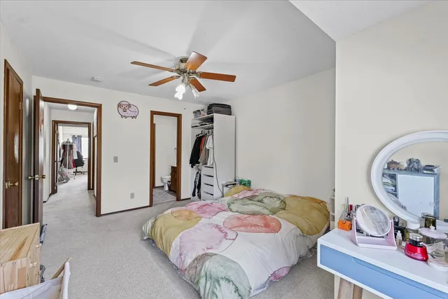 a bedroom with a bed a rug and a mirror