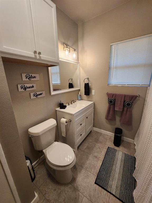 3736 Colonial Avenue Dallas, TX 75215 - Photo 3 of 9 a bathroom with a sink a toilet and vanity