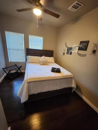 a bed sitting in a bedroom next to a lamp