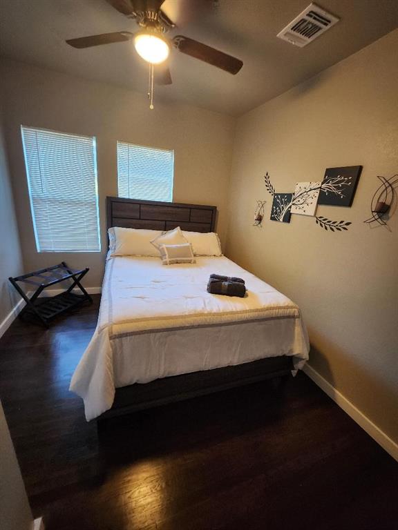 3736 Colonial Avenue Dallas, TX 75215 - Photo 6 of 9 a bed sitting in a bedroom next to a lamp