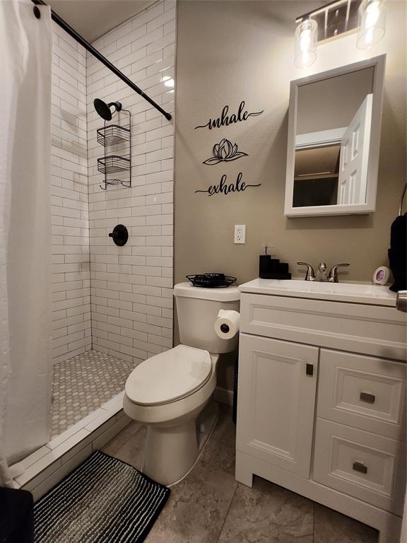 3736 Colonial Avenue Dallas, TX 75215 - Photo 7 of 9 a bathroom with a granite countertop toilet sink and mirror