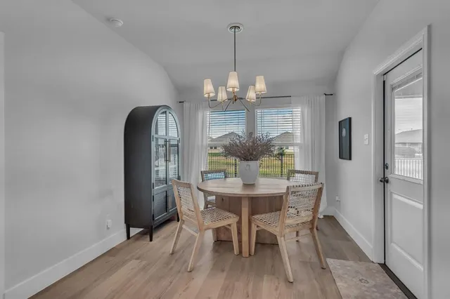 a living room with furniture a fireplace and a chandelier