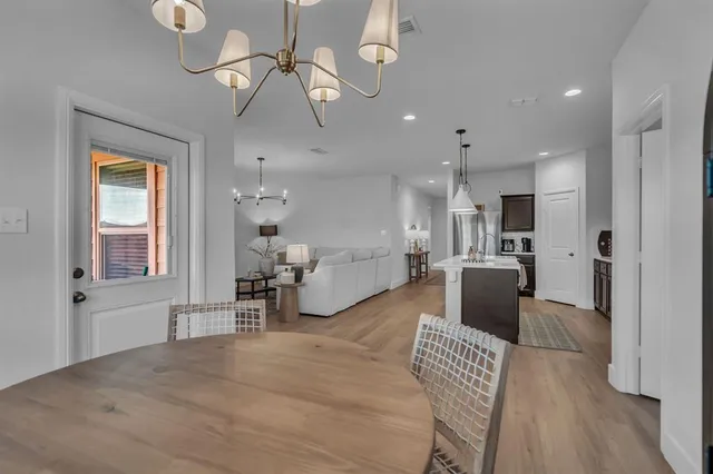 a view of a park with a slide and potted plants