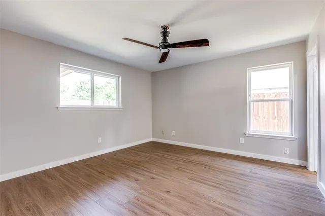a view of a room with wooden floor and windows