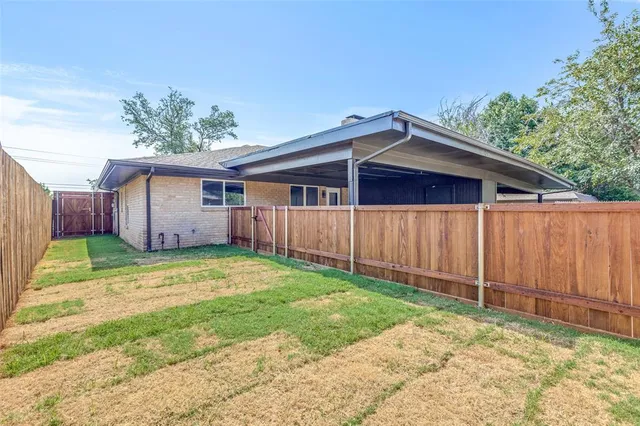 a backyard of a house with wooden fence