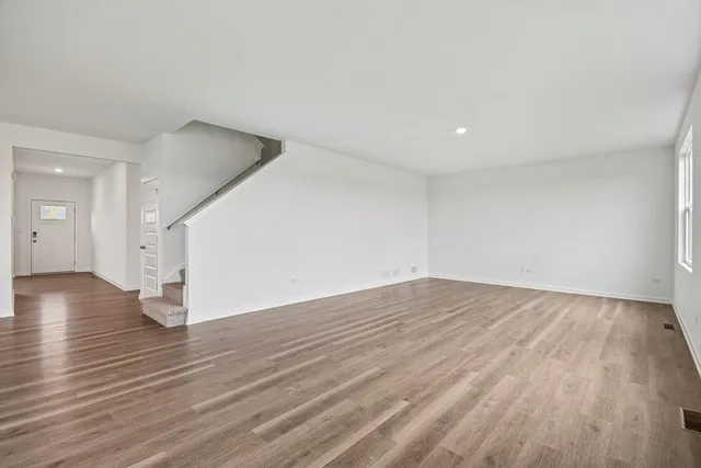 a living room with furniture a fireplace and a floor to ceiling window