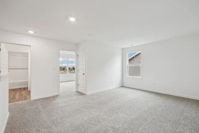 a living room with furniture kitchen view and a window