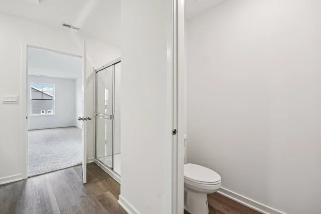 a spacious bedroom with a bed and large window